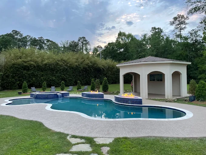 Renovated freeform pool with blue tile spa, fire features and pool house