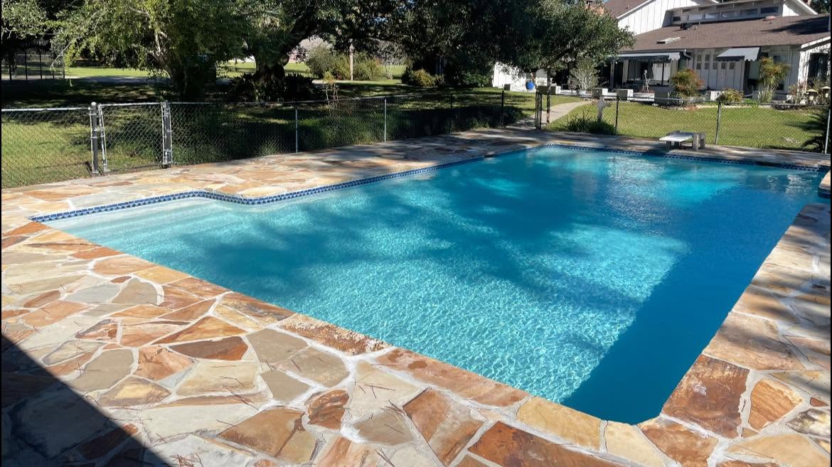 Classic rectangular pool with diving board and flagstone decking