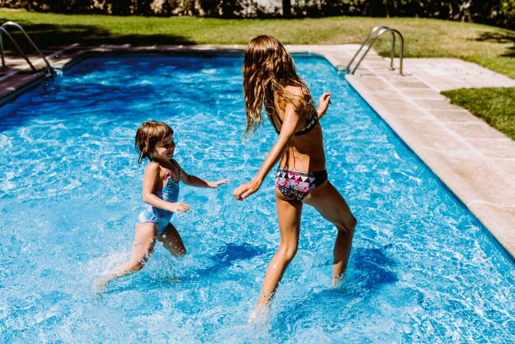 two-sister-kids-at-the-pool-playing